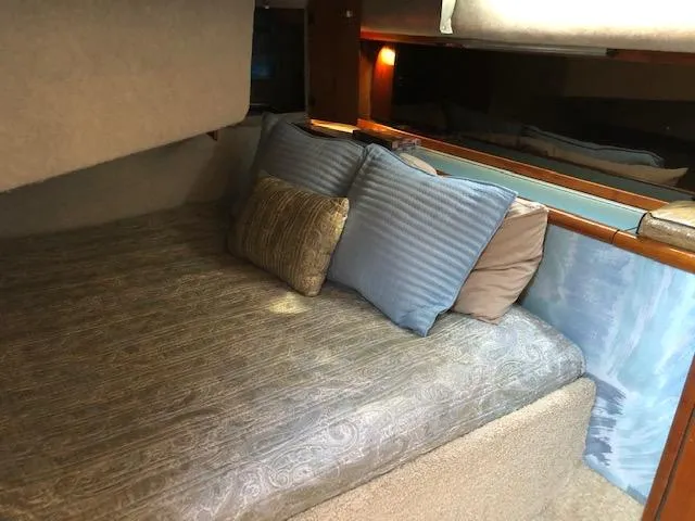 Slide: The Image of Cozy cabin interior of 1988 Bayliner 3818 Motoryacht with plush bedding and pillows. - 42