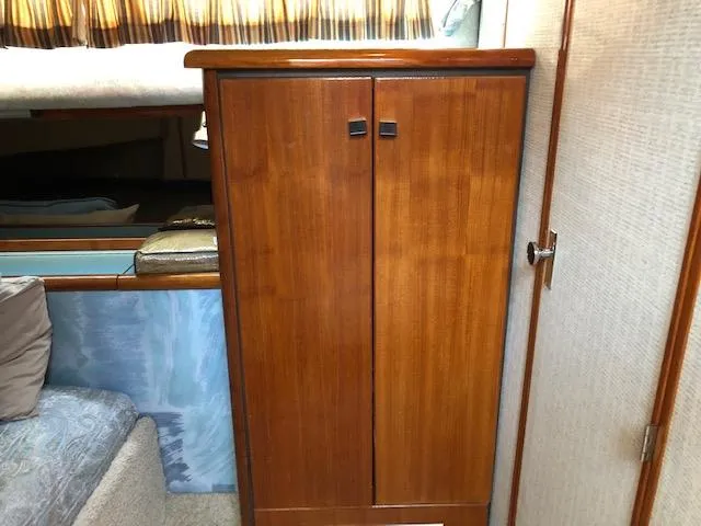 Slide: The Image of 1988 Bayliner 3818 Motoryacht interior with wooden cabinet and cozy seating area. - 43