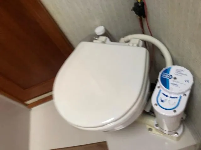 Slide: The Image of 1988 Bayliner 3818 Motoryacht bathroom with marine toilet and pump system. - 47