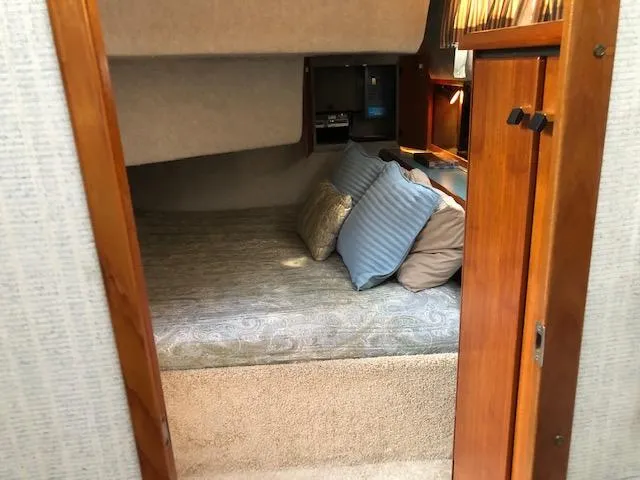 Slide: The Image of Cozy cabin interior of 1988 Bayliner 3818 Motoryacht with cushions and wood accents. - 48