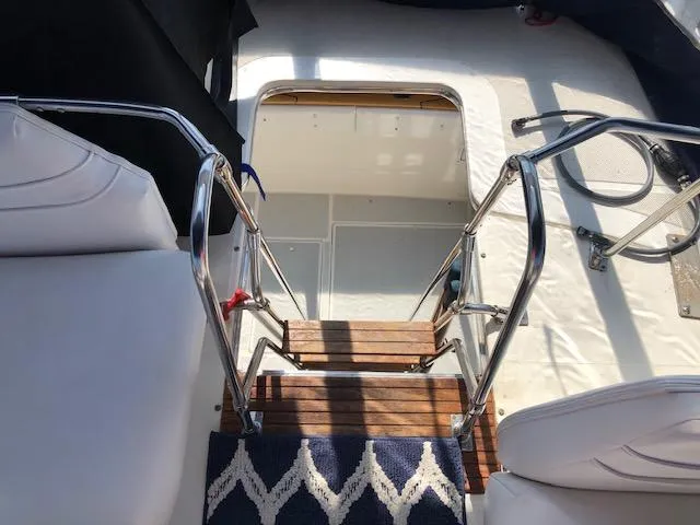 Slide: The Image of 1988 Bayliner 3818 Motoryacht interior with wooden steps and white seating. - 9