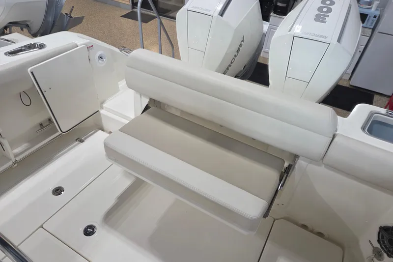 Slide: The Image of 2026 Boston Whaler 280 Outrage boat interior with seating and Mercury engines. - 11