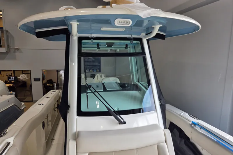 Slide: The Image of 2026 Boston Whaler 280 Outrage boat interior with windshield and seating. - 15