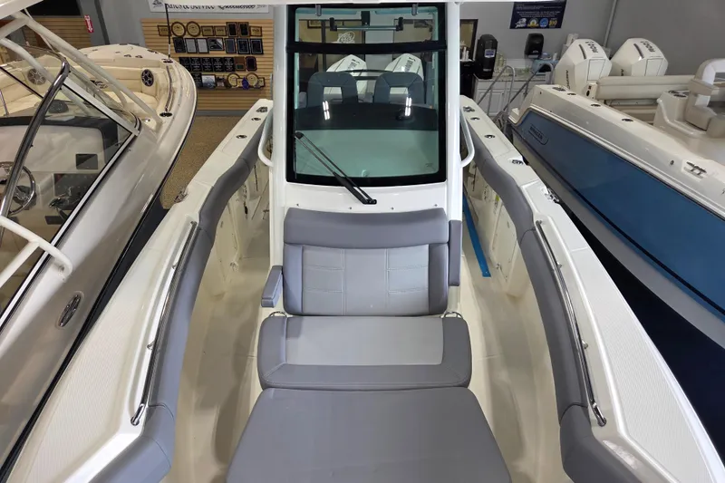 Slide: The Image of 2025 Boston Whaler 250 Outrage boat interior with seating and console view. - 12