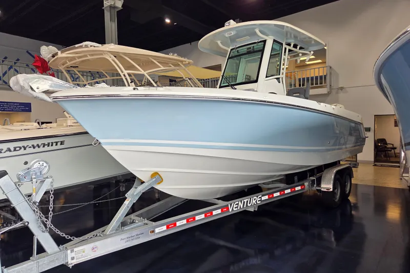 The Image of 2025 Boston Whaler 250 Outrage boat on trailer in showroom. - 2