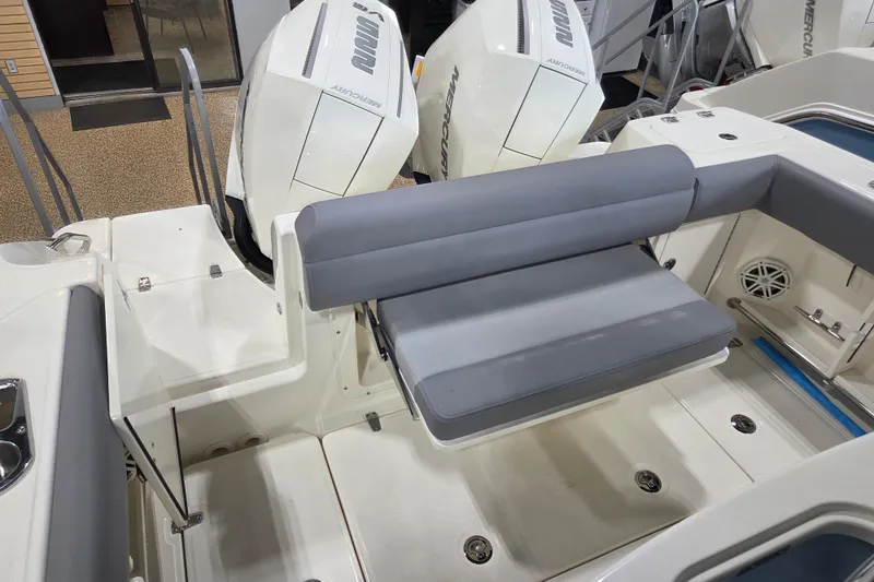 Slide: The Image of 2025 Boston Whaler 250 Outrage boat interior with seating and Mercury engines. - 7