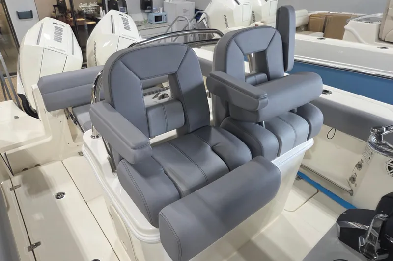 Slide: The Image of 2025 Boston Whaler 250 Outrage boat seats, featuring luxurious gray upholstery and modern design. - 8