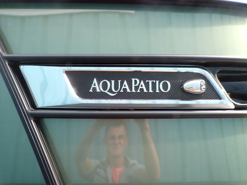 Slide: The Image of 2025 Godfrey AquaPatio 235 SBW iMPACT logo on boat exterior. - 13