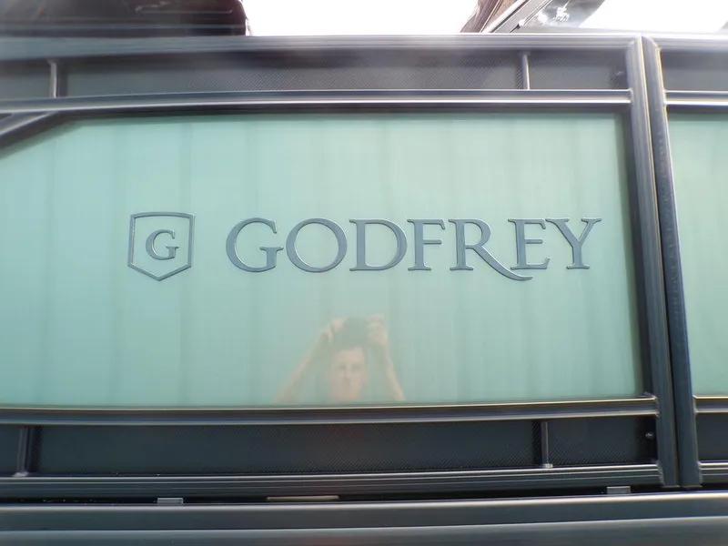 Slide: The Image of 2025 Godfrey AquaPatio 235 SBW iMPACT Package, logo on boat panel. - 14