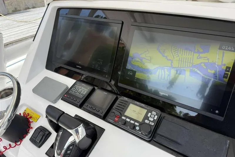 Slide: The Image of Control panel of a 2012 Intrepid 32 Open boat with Garmin navigation displays. - 3