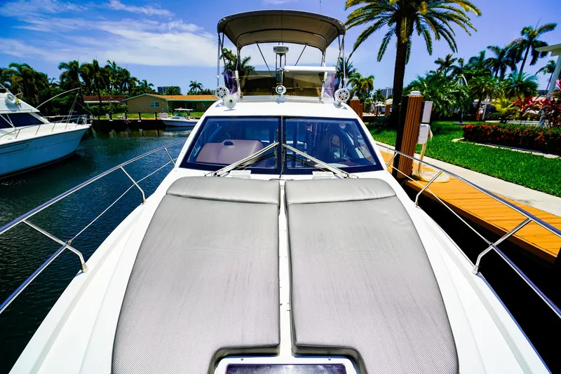 Slide: The Image of 2017 Azimut 42 Fly yacht docked, featuring sleek design and spacious deck under sunny skies. - 26