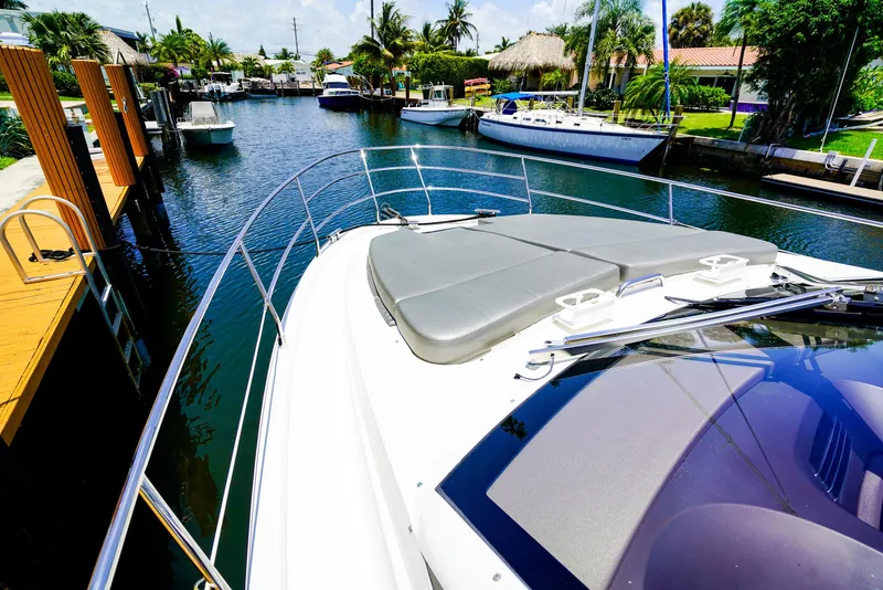 Slide: The Image of Azimut 42 Fly 2017 yacht docked in a scenic canal with palm trees. - 27