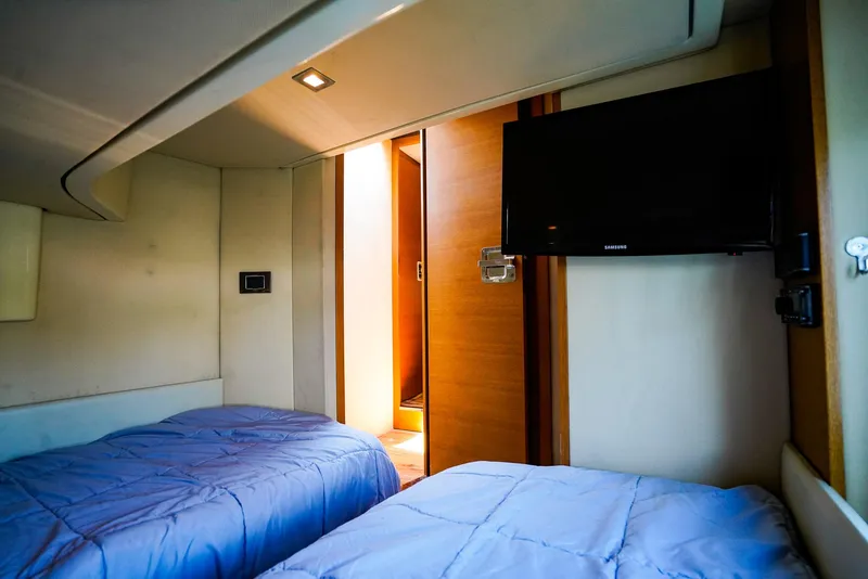 Slide: The Image of Interior of 2017 Azimut 42 Fly yacht cabin with twin beds and wall-mounted TV. - 40
