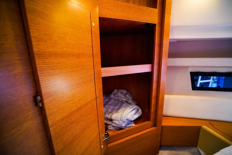 Slide: The Image of Wooden cabinet interior on 2017 Azimut 42 Fly yacht with folded linens. - 44