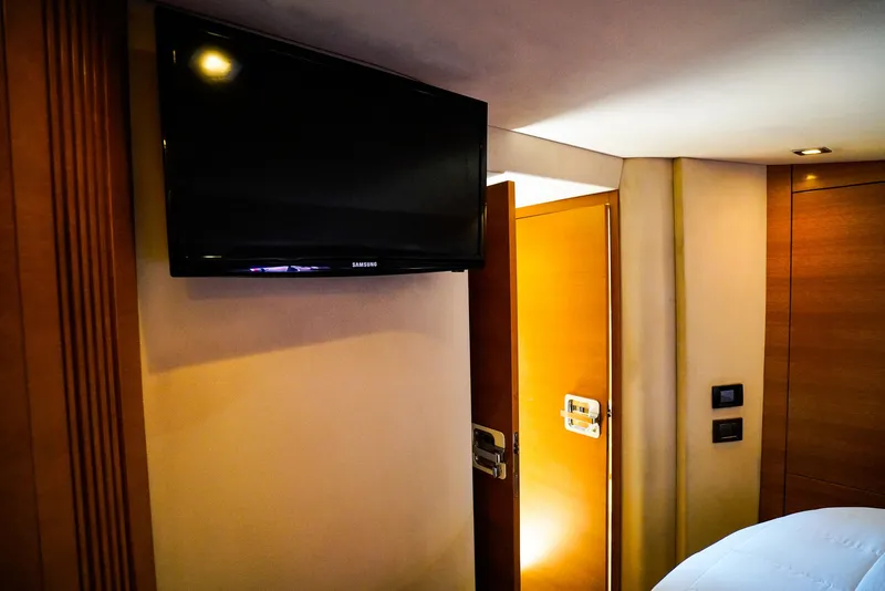 Slide: The Image of Interior of 2017 Azimut 42 Fly yacht with wall-mounted TV and wooden door. - 45