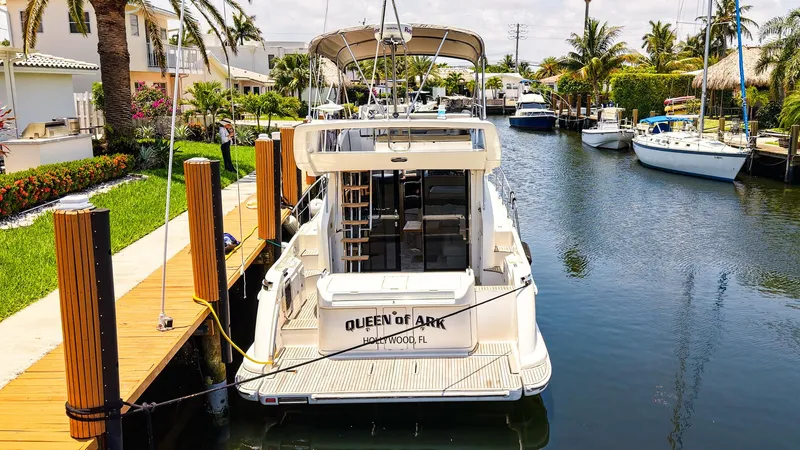 Slide: The Image of 2017 Azimut 42 Fly yacht docked in a scenic canal with lush surroundings. - 49