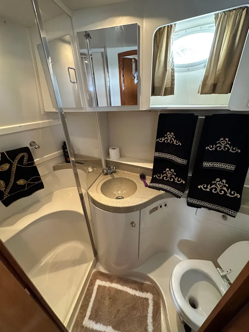 Slide: The Image of Elegant bathroom in 2002 Carver AFT CABIN yacht with modern fixtures and decorative towels. - 10