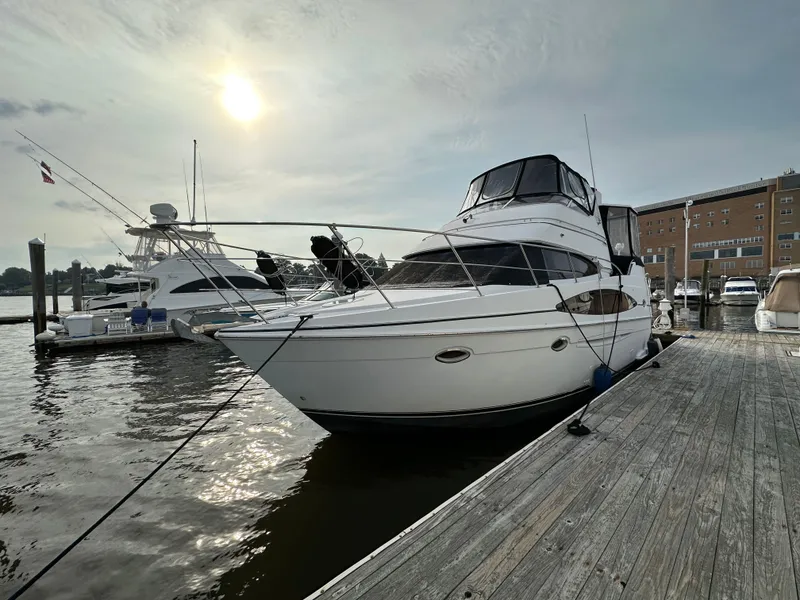Slide: The Image of 2002 Carver AFT CABIN yacht docked at marina under cloudy sky. - 2