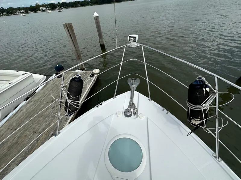 Slide: The Image of 2002 Carver AFT CABIN boat docked by a calm lake. - 24