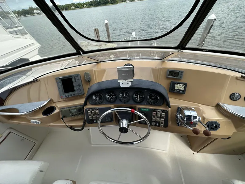 Slide: The Image of 2002 Carver AFT CABIN boat helm with steering wheel and navigation instruments. - 3