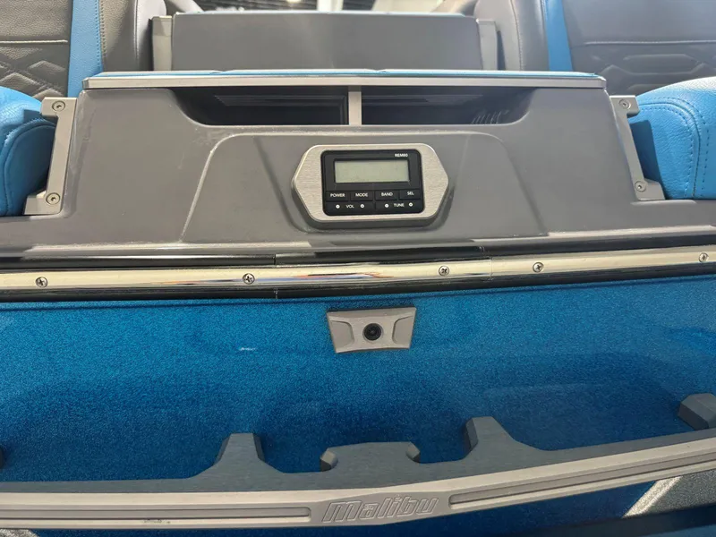 Slide: The Image of 2022 Malibu Wakesetter 25 LSV interior with control panel and blue upholstery. - 11