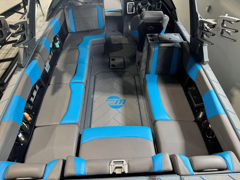 Slide: The Image of 2022 Malibu Wakesetter 25 LSV interior with blue and gray seating, modern dashboard. - 16