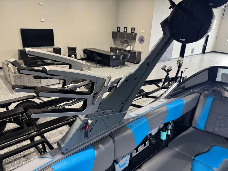 Slide: The Image of 2022 Malibu Wakesetter 25 LSV interior with blue accents and wakeboard rack. - 20