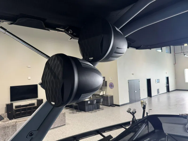 Slide: The Image of 2022 Malibu Wakesetter 25 LSV boat speakers in a showroom setting. - 21