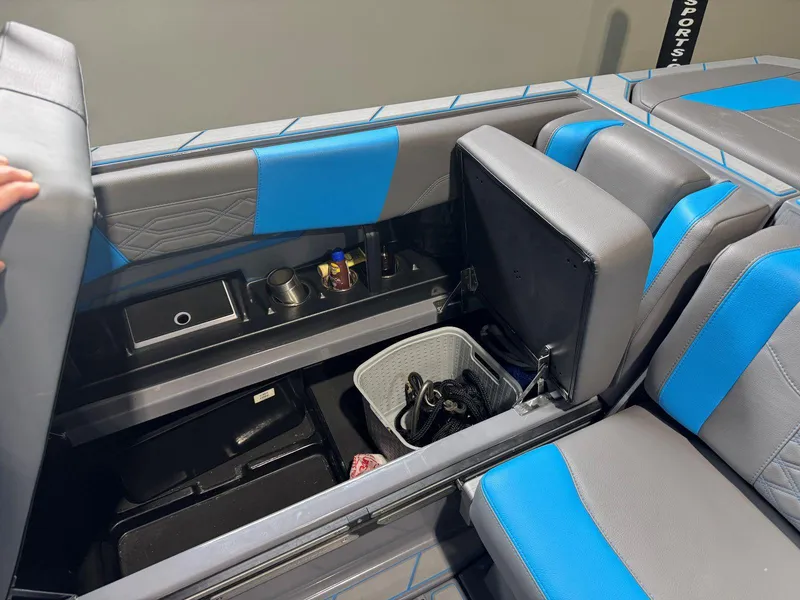 Slide: The Image of 2022 Malibu Wakesetter 25 LSV interior storage with blue and gray seating. - 25