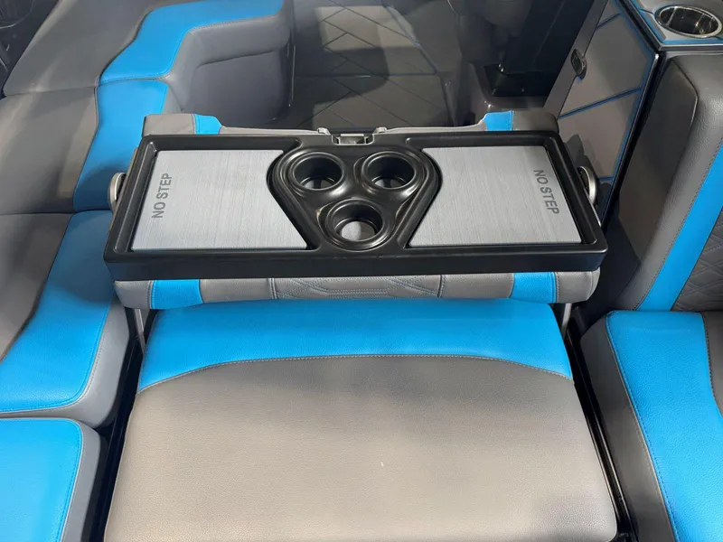 Slide: The Image of 2022 Malibu Wakesetter 25 LSV interior with blue and gray seating, featuring cup holders. - 30