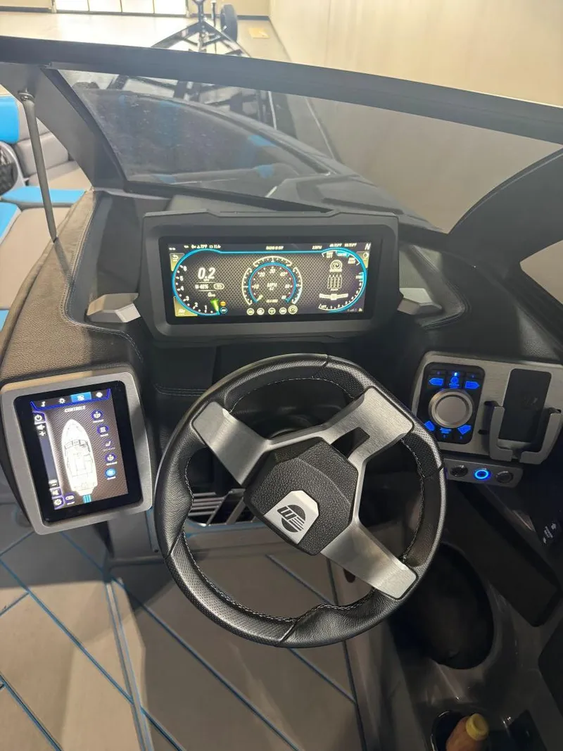 Slide: The Image of 2022 Malibu Wakesetter 25 LSV dashboard with digital displays and steering wheel. - 34
