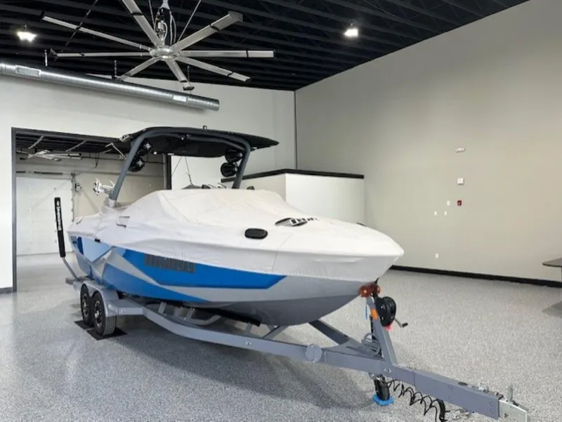 Slide: The Image of 2022 Malibu Wakesetter 25 LSV boat in a showroom on a trailer. - 49