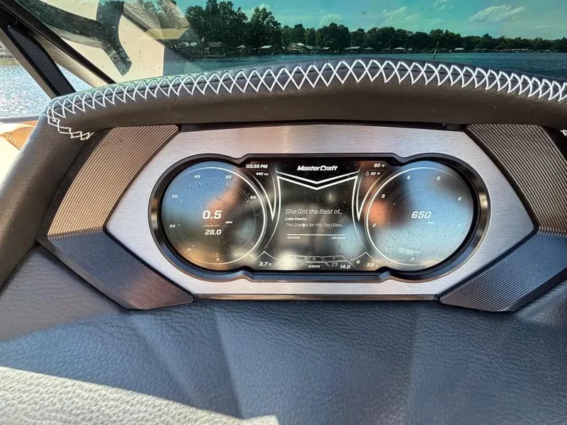 Slide: The Image of Dashboard of a 2019 MasterCraft XStar boat with digital display and steering wheel. - 11