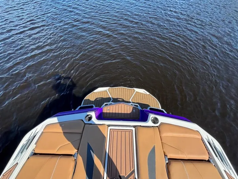 Slide: The Image of 2019 MasterCraft XStar boat with tan seats on calm water. - 15