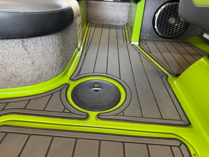 Slide: The Image of 2016 Malibu Wakesetter 23 LSV interior with green accents and speaker detail. - 14