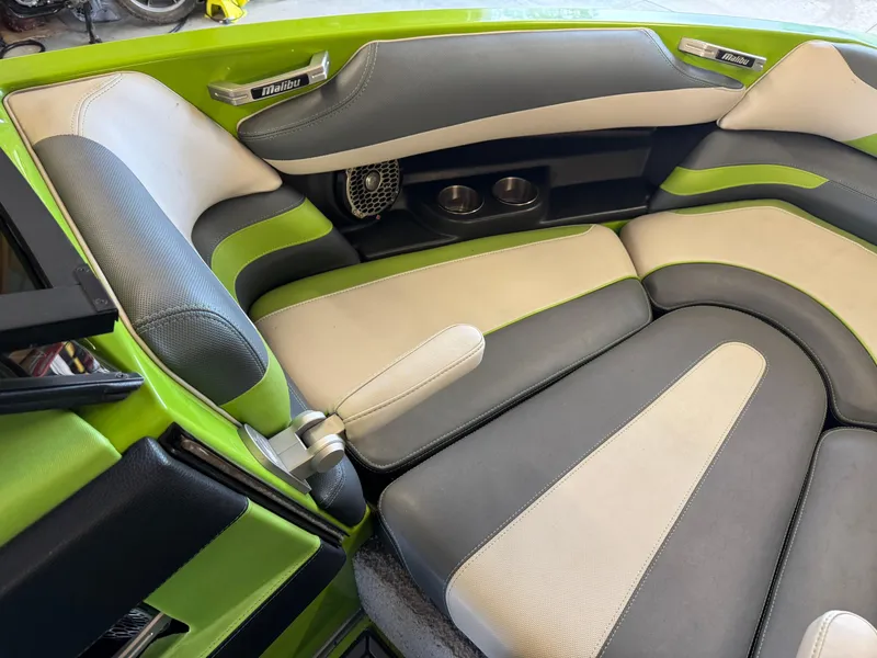 Slide: The Image of 2016 Malibu Wakesetter 23 LSV interior with green, gray, and beige seating. - 15