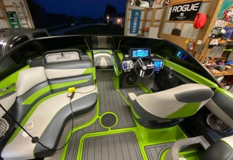 Slide: The Image of 2016 Malibu Wakesetter 23 LSV interior with green accents and modern dashboard. - 6