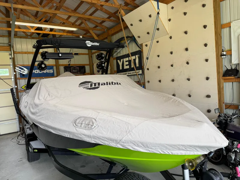 Slide: The Image of 2016 Malibu Wakesetter 23 LSV boat covered in a garage with climbing wall. - 7