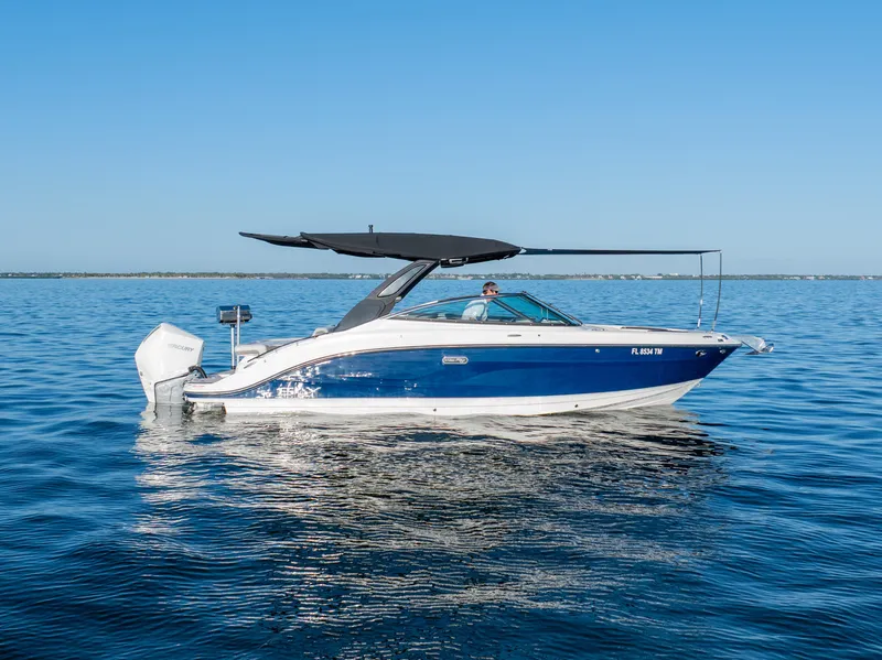 The Image of 2023 Sea Ray SLX 260 Outboard boat on calm blue water. - 0