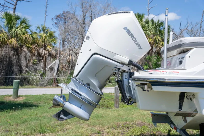 Slide: The Image of 2023 Sea Ray SLX 260 Outboard with Mercury engine, parked on grass. - 11
