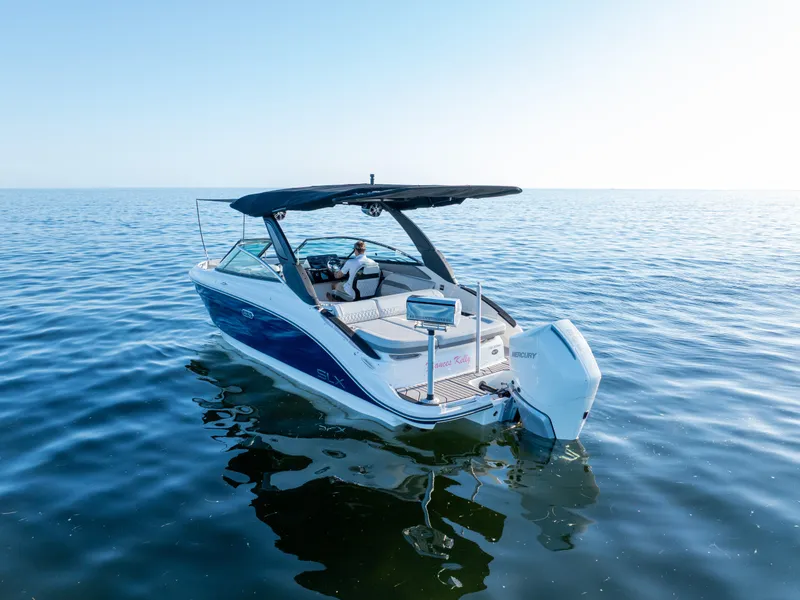 Slide: The Image of 2023 Sea Ray SLX 260 Outboard boat cruising on calm ocean waters. - 15