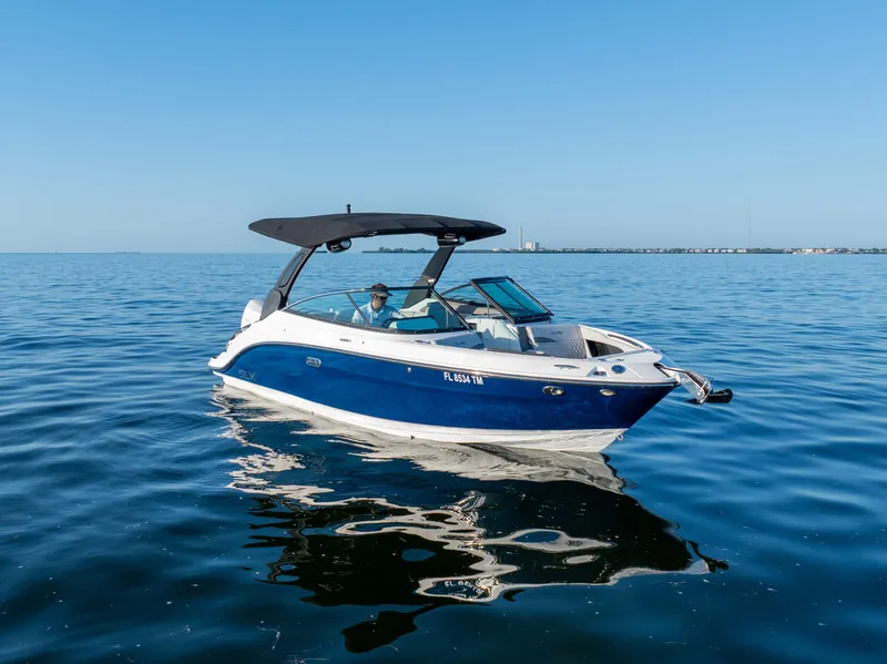 Slide: The Image of 2023 Sea Ray SLX 260 Outboard boat cruising on calm blue waters. - 17