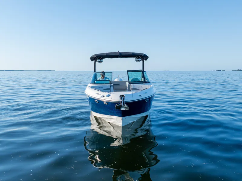 Slide: The Image of 2023 Sea Ray SLX 260 Outboard boat on calm blue water, front view. - 18