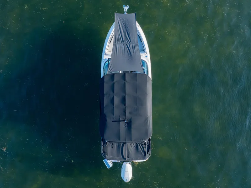 Slide: The Image of Top view of 2023 Sea Ray SLX 260 Outboard boat with cover on water. - 25