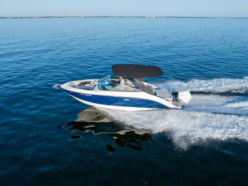 Slide: The Image of 2023 Sea Ray SLX 260 Outboard cruising on open water, showcasing sleek design and performance. - 26