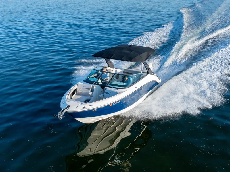 Slide: The Image of 2023 Sea Ray SLX 260 Outboard cruising on open water, showcasing sleek design and performance. - 27