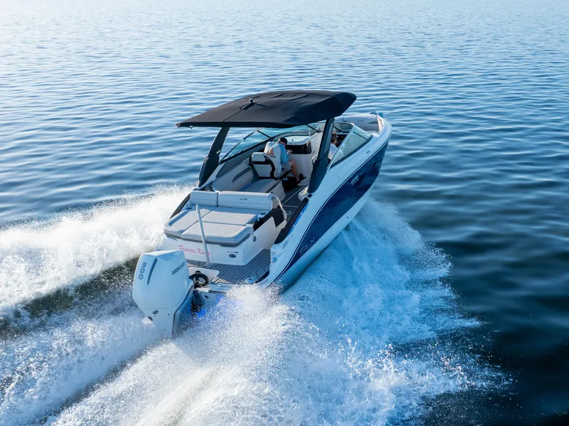 Slide: The Image of 2023 Sea Ray SLX 260 Outboard cruising on open water, showcasing sleek design and performance. - 28