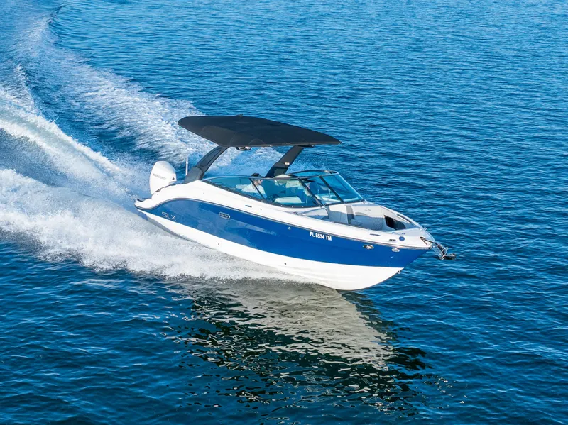 Slide: The Image of 2023 Sea Ray SLX 260 Outboard cruising on open water, showcasing sleek design and performance. - 30