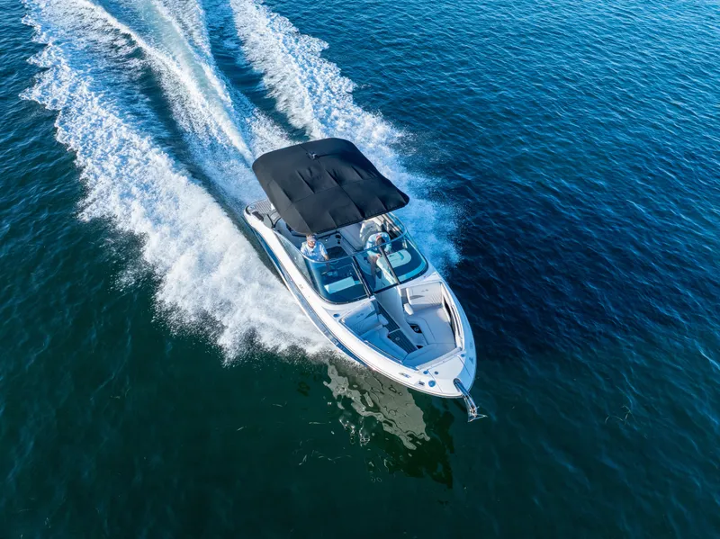 Slide: The Image of 2023 Sea Ray SLX 260 Outboard cruising on open water, aerial view. - 32