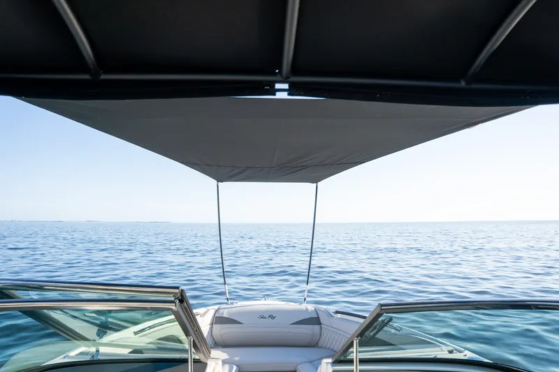 Slide: The Image of 2023 Sea Ray SLX 260 Outboard boat with canopy on open water. - 37